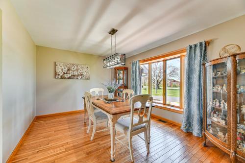 a dining room with a table and chairs and a window at Awesome Geneva Home with Patio Near Seneca Lake! in Geneva