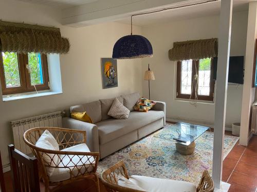 a living room with a couch and a glass table at La casina de Barro in Llanes
