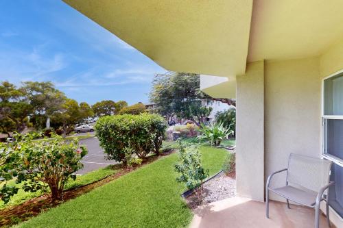 a view from a balcony of a house with a yard at Greens At Waikoloa J101 in Waikoloa Village