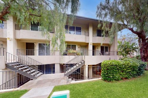 a building with stairs in front of a yard at Greens At Waikoloa J101 in Waikoloa Village