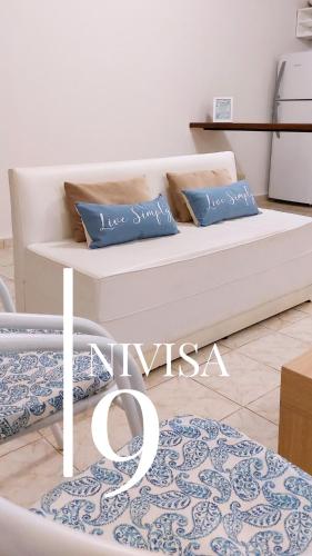 a white couch in a living room with blue pillows at Edificio NIVISA in Posadas