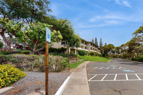 a street sign in a parking lot next to a building at Greens At Waikoloa J101 in Waikoloa Village