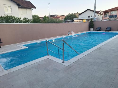 a swimming pool with blue water in a house at Juka in Međugorje