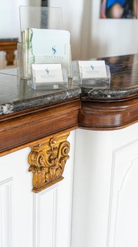 a table with three white boxes on top of it at Hotel Sinuessa Terme in Mondragone