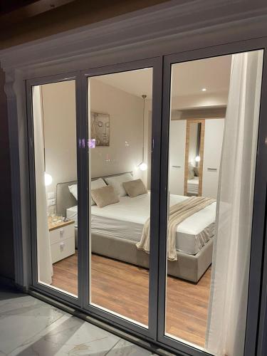a bedroom with a bed and a mirror at Bizant Boutique Hotel & Coffee,Bar in Durrës