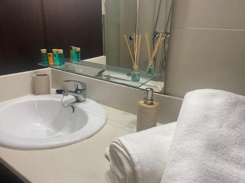 a bathroom with a sink and a mirror at Javea's Port apartment in Jávea