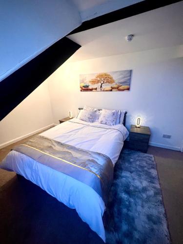 a bed in a room with an attic at Private Parking, Urban Comfort & City Haven in Plymouth