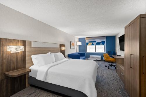a hotel room with a large bed and a desk at Holiday Inn Express Grove City - Premium Outlet Mall by IHG in Grove City