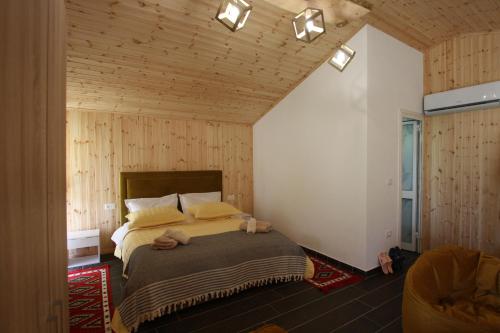 a bedroom with a bed with two stuffed animals on it at Lugina e Shengjergjit ,Bujtinat in Tirana