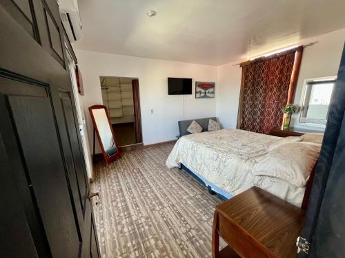 a bedroom with a bed and a television in it at Casa en Chapultepec California in Tijuana