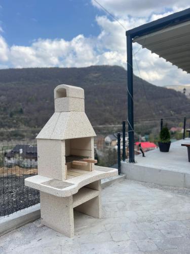 a stone oven sitting on top of a patio at Mavrovo Square " Villas & Apartment " in Mavrovo