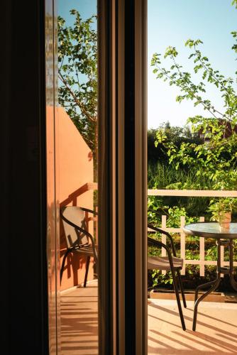 a view from a window of a patio with a table at Melador beachfront studios in Kavos