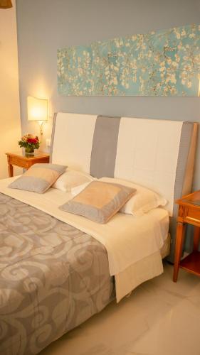 a bedroom with a large white bed with two pillows at Hotel Sinuessa Terme in Mondragone