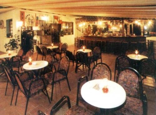 a restaurant with tables and chairs with candles on them at Eleni Apartments in Hersonissos