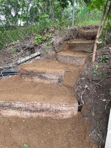 a set of stone steps on a dirt hillside at Pet friendly Tiny House Rental with new Access to Guadalupe River NBTX in New Braunfels