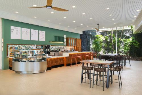 a restaurant with tables and chairs and a counter at OUTRIGGER Kona Resort and Spa in Kailua-Kona