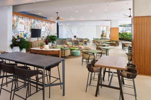 a restaurant with tables and chairs in a room at OUTRIGGER Kona Resort and Spa in Kailua-Kona