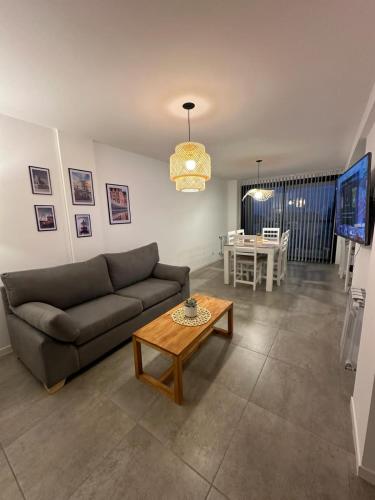 a living room with a couch and a table at Departamento Paso 3244 in Mar del Plata