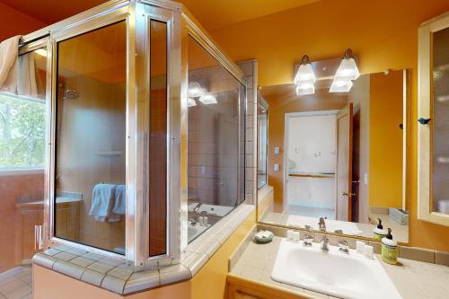 a bathroom with a shower and a sink at Sunset View House in Lopez