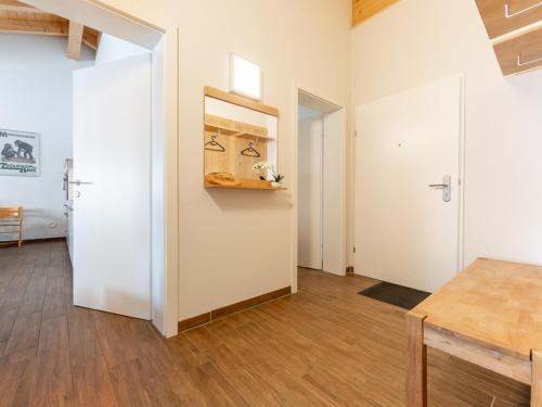 a room with a white door and wooden floors at Emma Top 3 in Dienten am Hochkönig