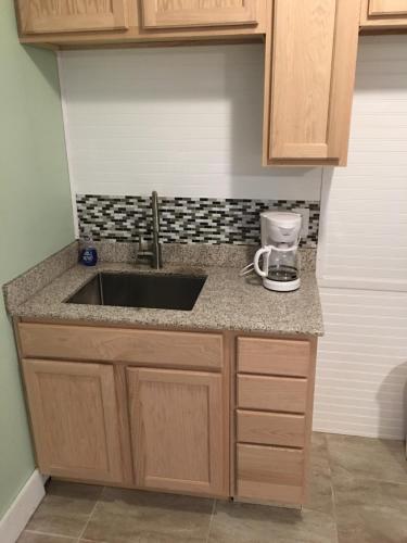 a kitchen counter with a sink and a coffee maker at The Catalina in Panama City Beach
