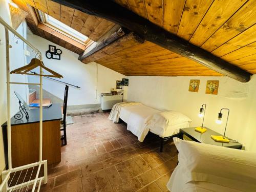 a bedroom with two beds and a wooden ceiling at Il Magnifico Firenze in Florence