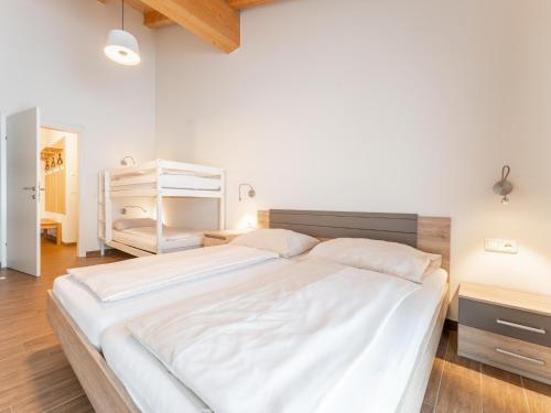 a bedroom with a large white bed in a room at Emma Top 3 XL in Dienten am Hochkönig
