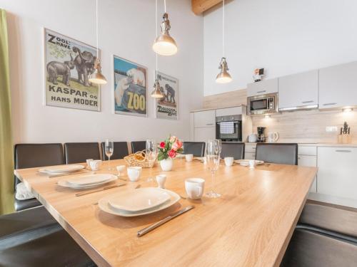a large wooden table in a room with a kitchen at Emma Top 3 in Dienten am Hochkönig