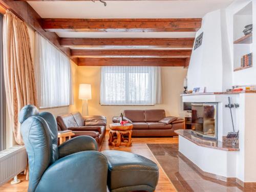 a living room with leather furniture and a fireplace at Haus Sonnberg in Hinterthal