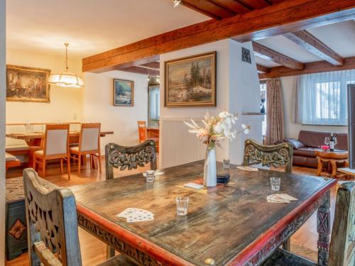 a dining room and living room with a large wooden table at Haus Sonnberg in Hinterthal