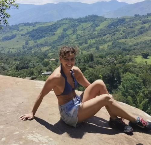 a young man sitting on top of a mountain at La Cabaña Eco Hotel in Suaita