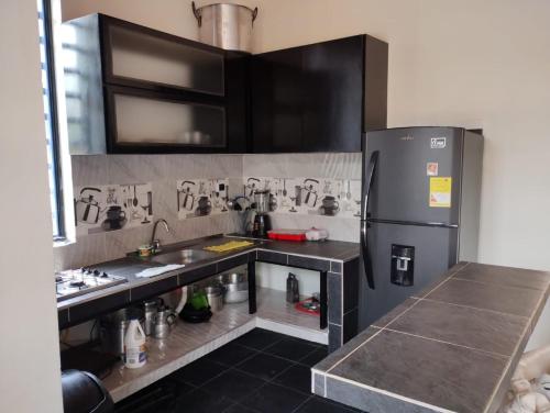 a kitchen with a stainless steel refrigerator and counters at casa turística La Alameda in Carmen de Apicalá