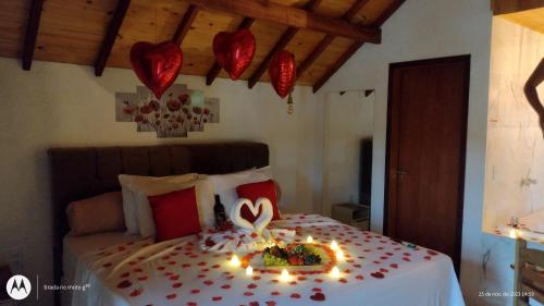 a bedroom with a bed with candles on it at Pousada Solard'isabell in Monte Verde