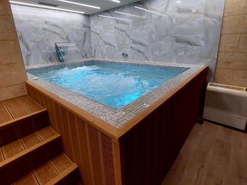 a large jacuzzi tub in a room with at Happy Dreams Spa Zlatibor in Zlatibor