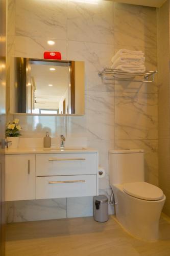 a bathroom with a toilet and a sink and a mirror at Luxury, Ocean View, Pool, Jacuzzi, Valle de Guadalupe, Los Portales De Garcia, Splash, Encanto Restaurants, Surf Breaks in Primo Tapia, Rosarito in Rosarito