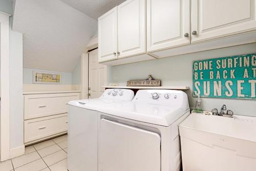 a white laundry room with a washer and dryer at 13 Green Winged Teal in Fernandina Beach