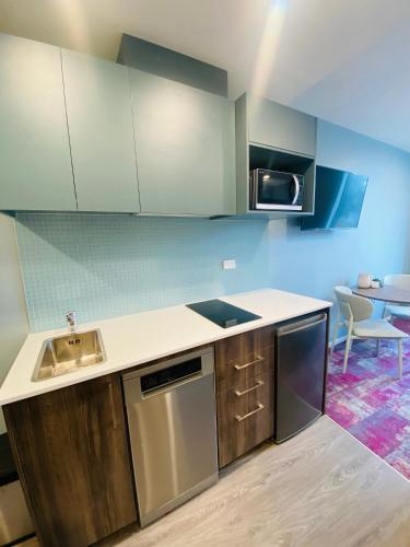 a kitchen with a sink and a stove top oven at La Quinta by Wyndham Parnell Auckland in Auckland