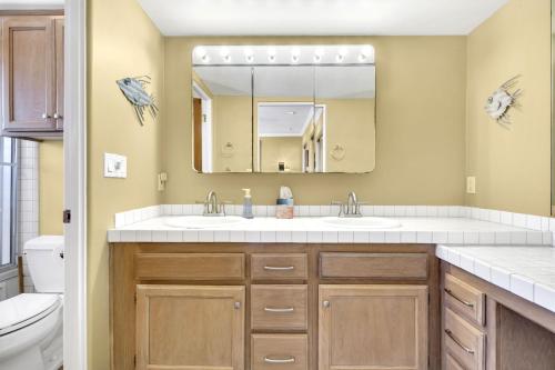 a bathroom with two sinks and a mirror at Pine Street #2 in Oceanside