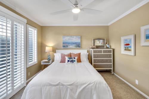 a bedroom with a white bed and windows at Pine Street #2 in Oceanside