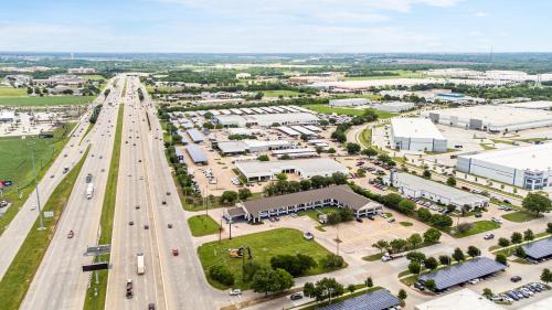 an aerial view of a city with a highway at Days Inn by Wyndham McKinney in McKinney
