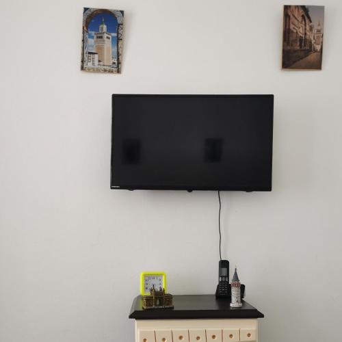 a flat screen tv hanging on a wall at Dar Mima Baya in Tunis