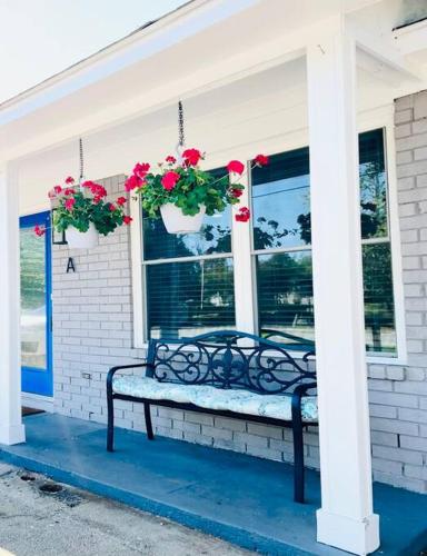a bench on the front of a house with flowers at Gemstones Sleeps 8 Perfect for Groups in Ladson