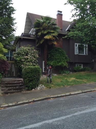 a person standing in front of a house at fabulous beach side apartment in Vancouver
