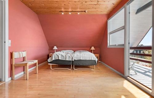a bedroom with a bed and a large window at 4 Bedroom Gorgeous Home In Skagen in Skagen