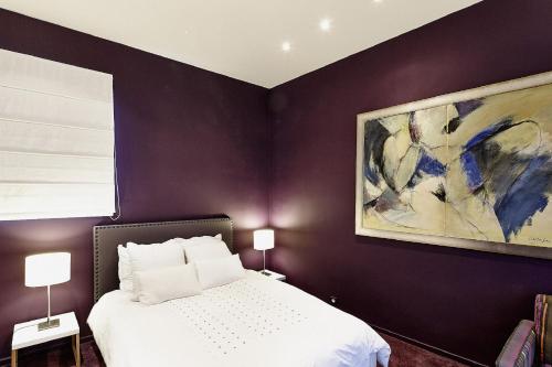 a bedroom with a bed and a painting on the wall at Maison d'hôtes Bordeaux Centre Le Patio de l'Intendance in Bordeaux