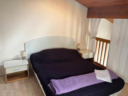 - une chambre avec un lit noir et 2 tables de chevet dans l'établissement Maison Jumelée à Biscarrosse Plage, Proche Océan et Centre, 6 Pers, Parking Privé, Récent, Non Fumeur - FR-1-521-67, à Biscarrosse-Plage