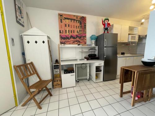 a kitchen with a refrigerator and a doll on top of it at Appartement Argelès-sur-Mer, 3 pièces, 4 personnes - FR-1-309-416 in Argelès-sur-Mer
