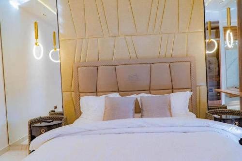 a bedroom with a large white bed with white pillows at Sujimoto Shortlet Ave Forche, Banana Island, Ikoyi in Ikoyi