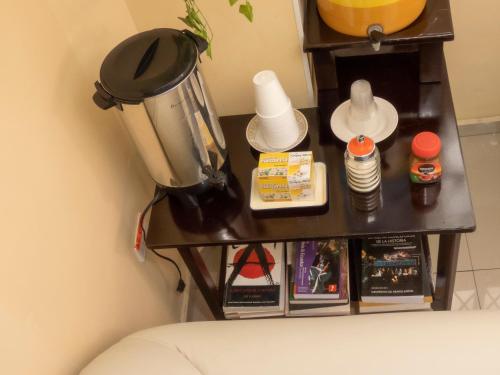 a table with a blender and other items on it at Hotel El Ejido in Quito