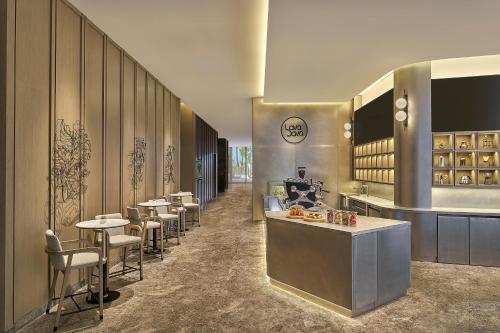 a restaurant with a row of tables and chairs at Marriott Executive Apartments Penang in George Town